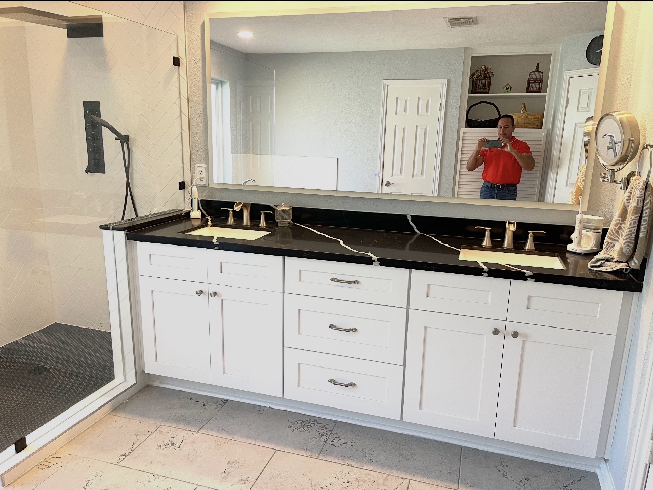Black quartz double vanity with white cabinets
