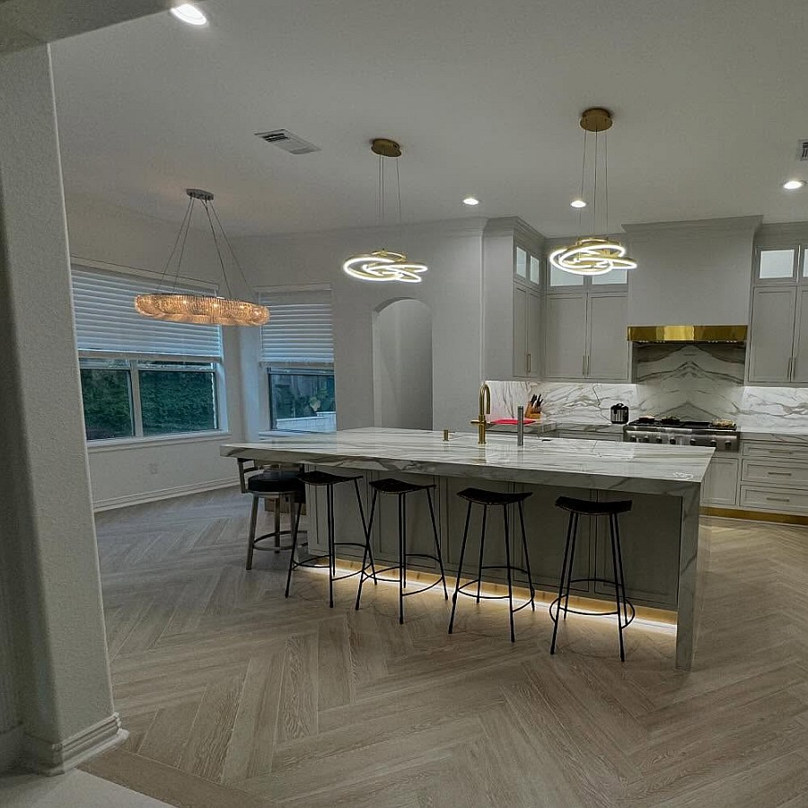 Kitchen remodel with herringbone wood floor and marble island