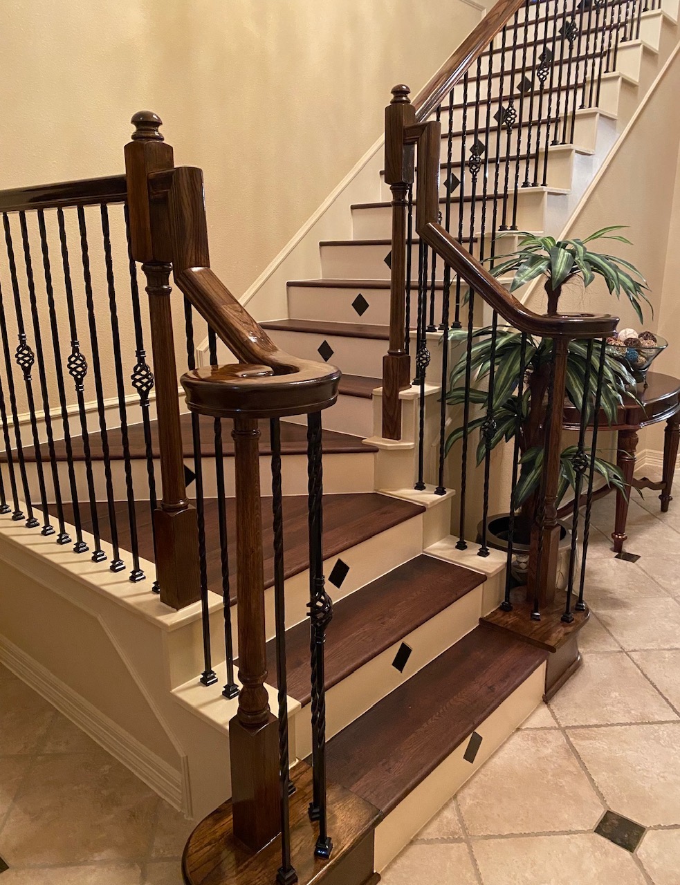 Refinished wood stair treads with iron balusters